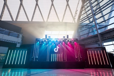 There was also a central bar, a stage with laser FX, curated refreshments, and TikTok trend-themed lounges for creators to connect and curate content. The space featured multiple creation stations including an 'up and away' video moment where creators soared through the clouds and a 'flight path' logo treatment, highlighting TikTok as the ultimate destination for creation.