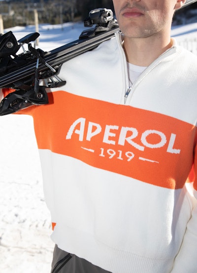 This year, Aperol is popping up at The Snow Lodge at The St. Regis Aspen Resort and sponsoring three performances of the resort’s Après-Ski Music Series, in addition to programming at other mountain towns across the U.S., such as locations in Colorado, California, Nevada, and Montana. To complement its winter events, the spirits brand also recently dropped its Après Ski Collection that includes beanies, thermal sets, hoodies, sweaters, and T-shirts.