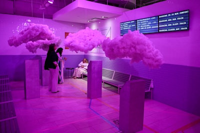 Another fun space is the 'Dream Reading Station,' modeled after a train station—nodding to both the NYC locale and the idea of traveling through various stages of sleep. Benches, rotary phones, white subway tile, and puffy clouds complete the look.