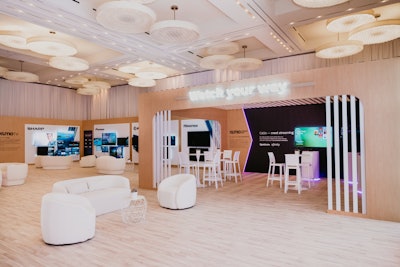 Four meeting rooms were transformed with custom demo walls showcasing the latest features, monochromatic chairs with succulent centerpieces, and a custom plum gradient vinyl and façades. The venue’s Vinyl Ballroom was also transformed, with drapery covering the entire space, fabricated walls featuring wood laminate and vinyl, 35 mounted Xumo TVs, and a 14-foot-long LED screen from 4Wall. A “watch your way” hub featured a dimensional chevron popout.