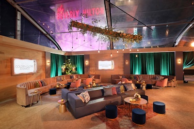Housed in a clear-top tent, the event’s decor featured neutral tones with pops of color and hanging greenery. Seating was a mix of plush couches and round tables. For food, the event offered a large sushi bar plus cheeseburger sliders and mini grilled cheese sandwiches with tomato soup.