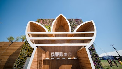 Another fun usage of large-scale logos came from Adidas and Bad Bunny's memorable team-up on festival grounds. The Adidas Campus Experience, a cube-shaped pop-up that celebrated the pair’s latest sneaker release, featured a massive Adidas logo made from steel and pine that highlighted a shopping experience. On the other side of the flower-covered cube, Bad Bunny’s signature logo served as an entrance tunnel. The activation was produced by Corso Marketing Group and fabricated by Whalefilm.
