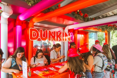 Other highlights included a bracelet-making station, airbrush tattoos, iced coffee samples, and a second-floor lounge with plush seating areas and views of the festival grounds below.