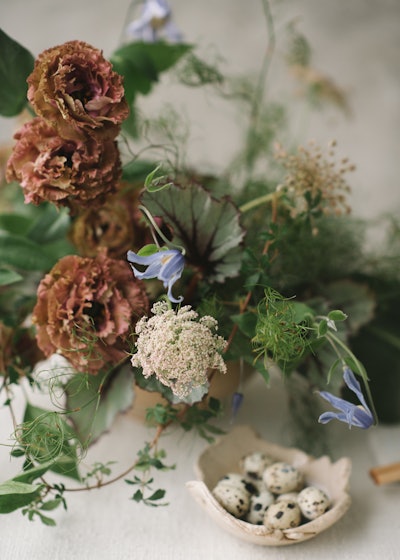 “With a nod to ikebana, the centuries-old Japanese art of flower arranging, Studio Mondine carefully installed brown lisianthus, smoke bush, carrot flower, blue clematis, koala fern, and purple allium in a variety of low vessels, using floral frogs to securely hold the stems in place,” reads an excerpt from Hotchkiss’ book about a weekend event held on Naoshima Island in Japan.