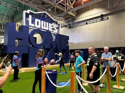 Lowe’s, the official home improvement partner of the NFL, hosted a six-zoned booth that included the 'Home Team Toss,' where fans tried to throw a football through the O of a large display.