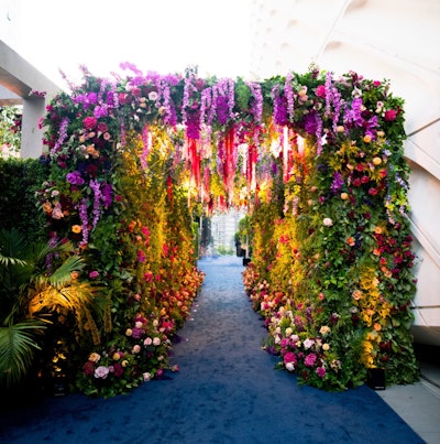 This dreamy, museum-inspired floral tunnel was created for Disney's 2022 Emmys party, where 'modern botanic brilliance' was the theme. Sterling Engagements worked with ENSO Creative on the floral design and decor, which mixed jewel tones, botanical greens, and luxe blooms. See more: Emmys 2022: Inside Parties From Netflix, Disney, Paramount, and More